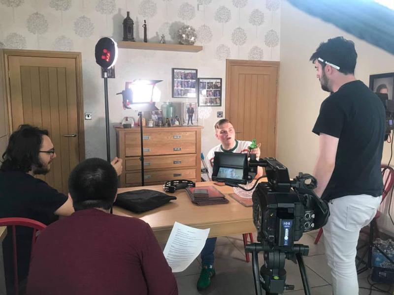 Behind the scenes for A Manchester Story - group sitting around a desk